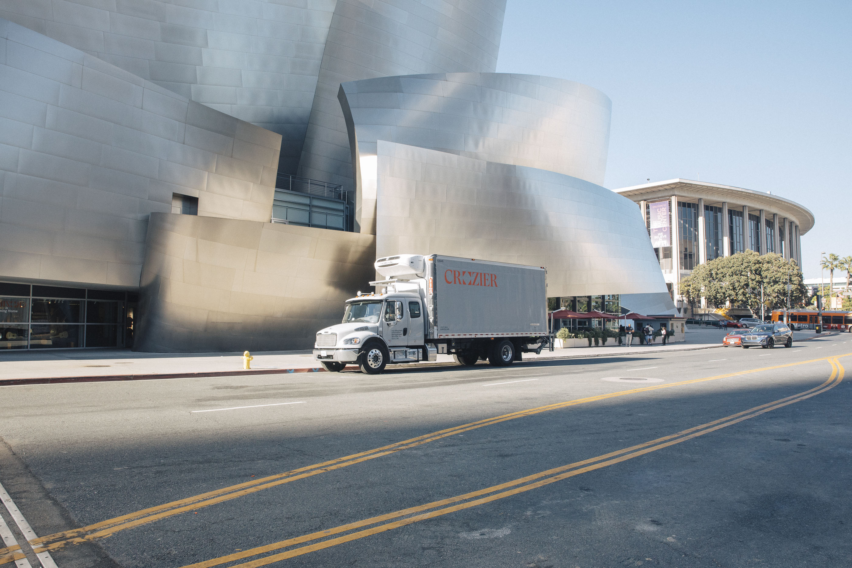  A Crozier truck navigates downtown Los Angeles, driving by the Walt Disney Concert Hall