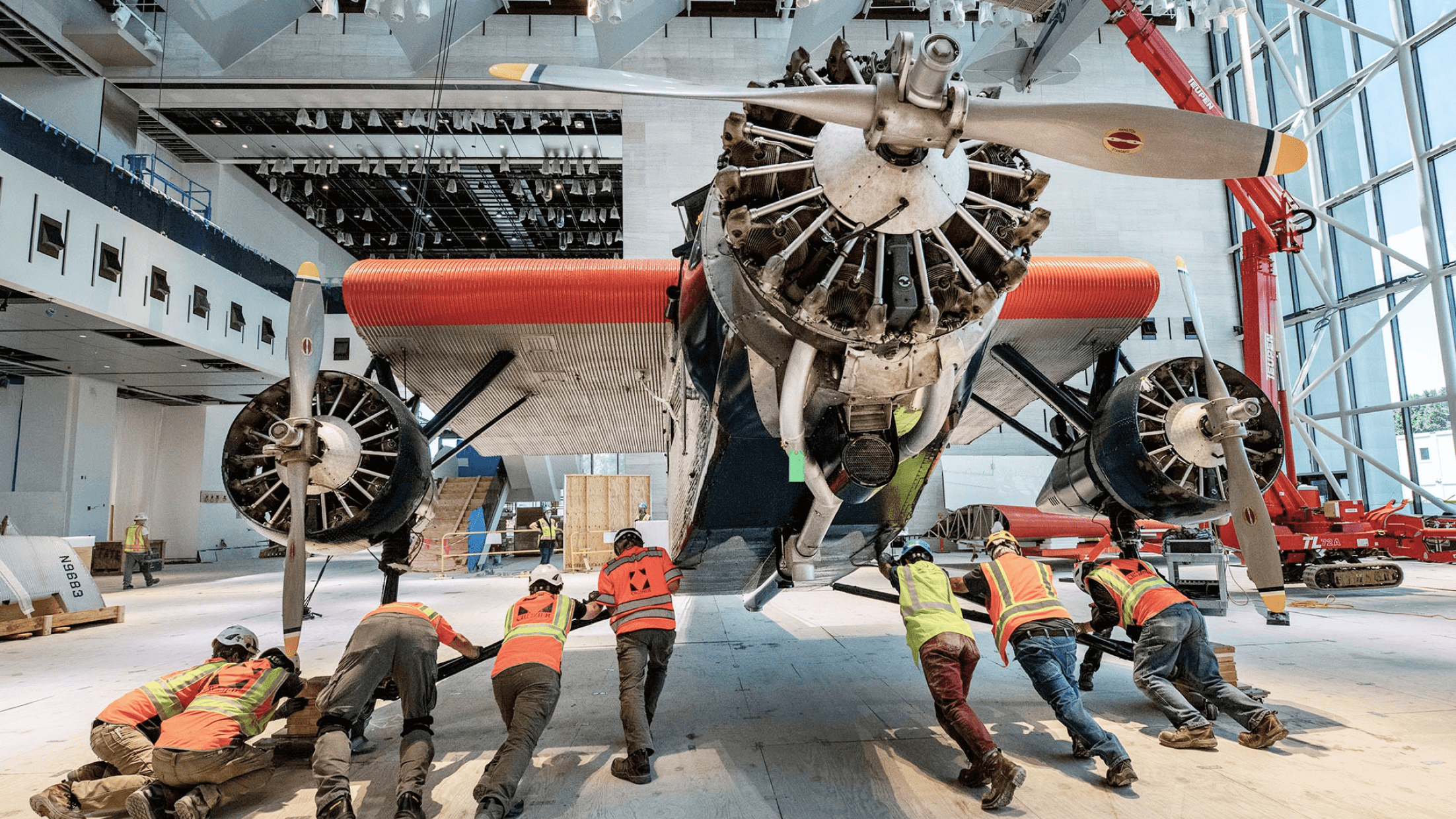 Crozier team members navigate the "Tin Goose," a 1928 Ford 5-AT Tri-Motor into place in the "America by Air" gallery. Photo courtesy of Jim Preston / The Washingtonian