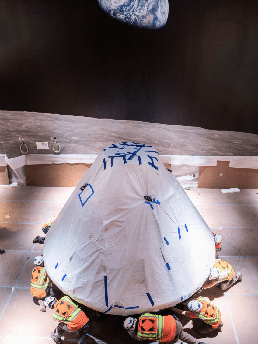 Crozier technicians get ready to mount the Apollo 11 command module, called Columbia, in the "Destination Moon" gallery. Photo courtesy of Jim Preston / The Washingtonian