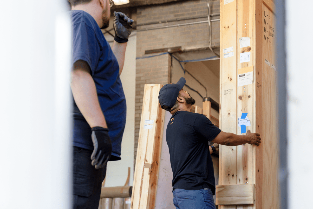 An expert art handler carefully moves a crate containing an Anish Kapoor piece